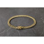 A 9 ct gold curb link bracelet, with saf