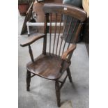 A Elm seated spindle back armchair of La