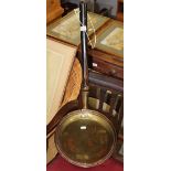 A Victorian brass and copper warming pan