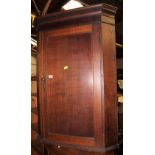 A George III mahogany corner cupboard wi