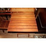 A modern folding teak garden table and t