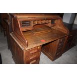 An early 20th century oak tambour fronte