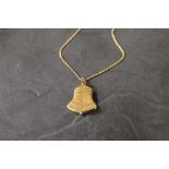 A 9 ct gold bell form locket pendant and