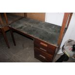 An early 20th century oak desk with thre