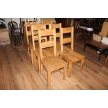 A group of six heavy modern oak dining c