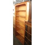 A modern pine bookcase with six tiers, d