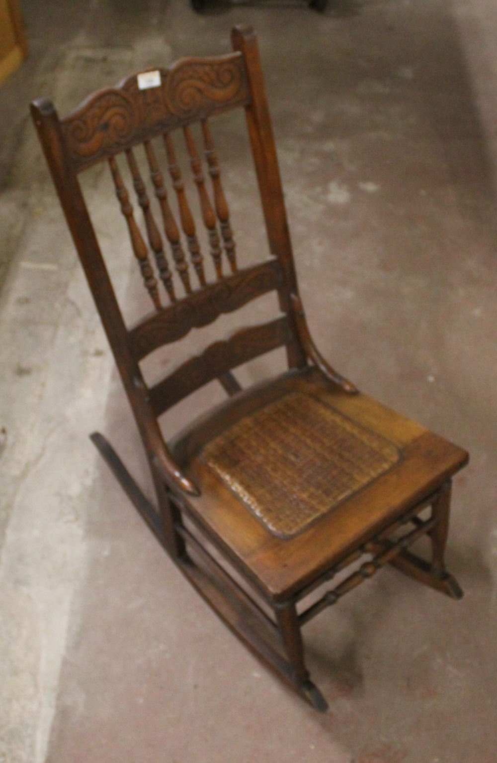 A Victorian cane seated rocking chair wi