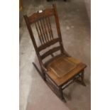 A Victorian cane seated rocking chair wi