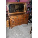 An Art Nouveau oak mirror back sideboard