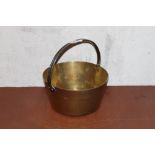 A Victorian brass jam pan with iron over