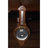 A vintage wheel barometer and thermomete