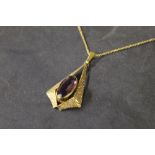 A rolled gold and amethyst pendant, the