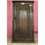 An Edwardian carved oak cabinet of small
