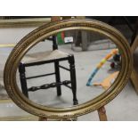 An oval gilt framed. 49 cm x 59 cm.