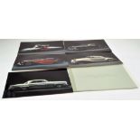 Automobilia Group comprising ex Mercedes Dealership photograph pack of various classic issues.