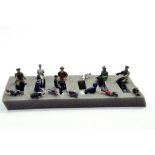 A group of seated lead metal figures from various makers including Lesney, Crescent, Benbros,