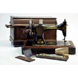 A vintage Singer Sewing machine with Wooden Case (very heavy) in addition to accessory items plus