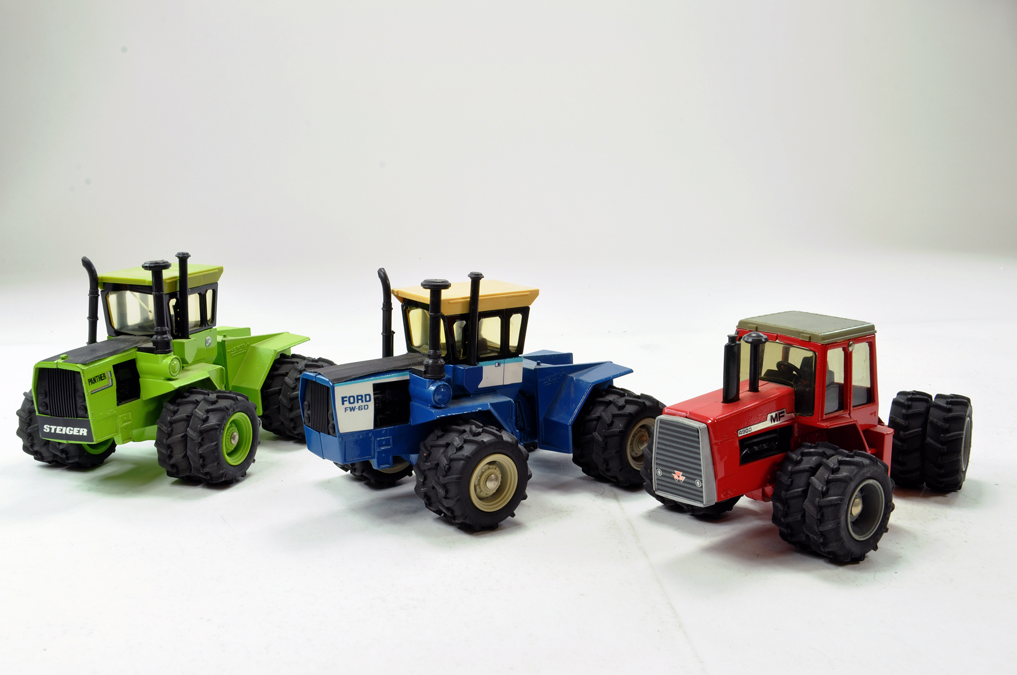 Ertl 1/32 Tractor trio comprising Ford FW60, MF4900 and Steiger Panther. Generally VG.