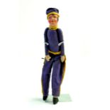 An unusual, likely rare, 10 ½” early 1900’s Bellhop Cloth Boy. Theatrical doll. Purple uniform