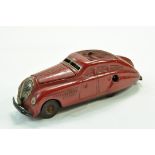 An original Schuco Commando Anno tinplate clockwork car in red. Generally fair to good, mechanism