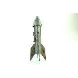 An unusual large metal US issue savings bank in the form of a rocket. Damaged hence fair only. Note: