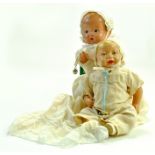 An 8 1/2” Antique Vintage Composition Baby Doll. Unmarked. Wearing a cream christening gown in