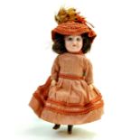 Antique Bisque Mignonette Doll Marked 15 on back of head. 9". Glass blue eyes, painted lashes,