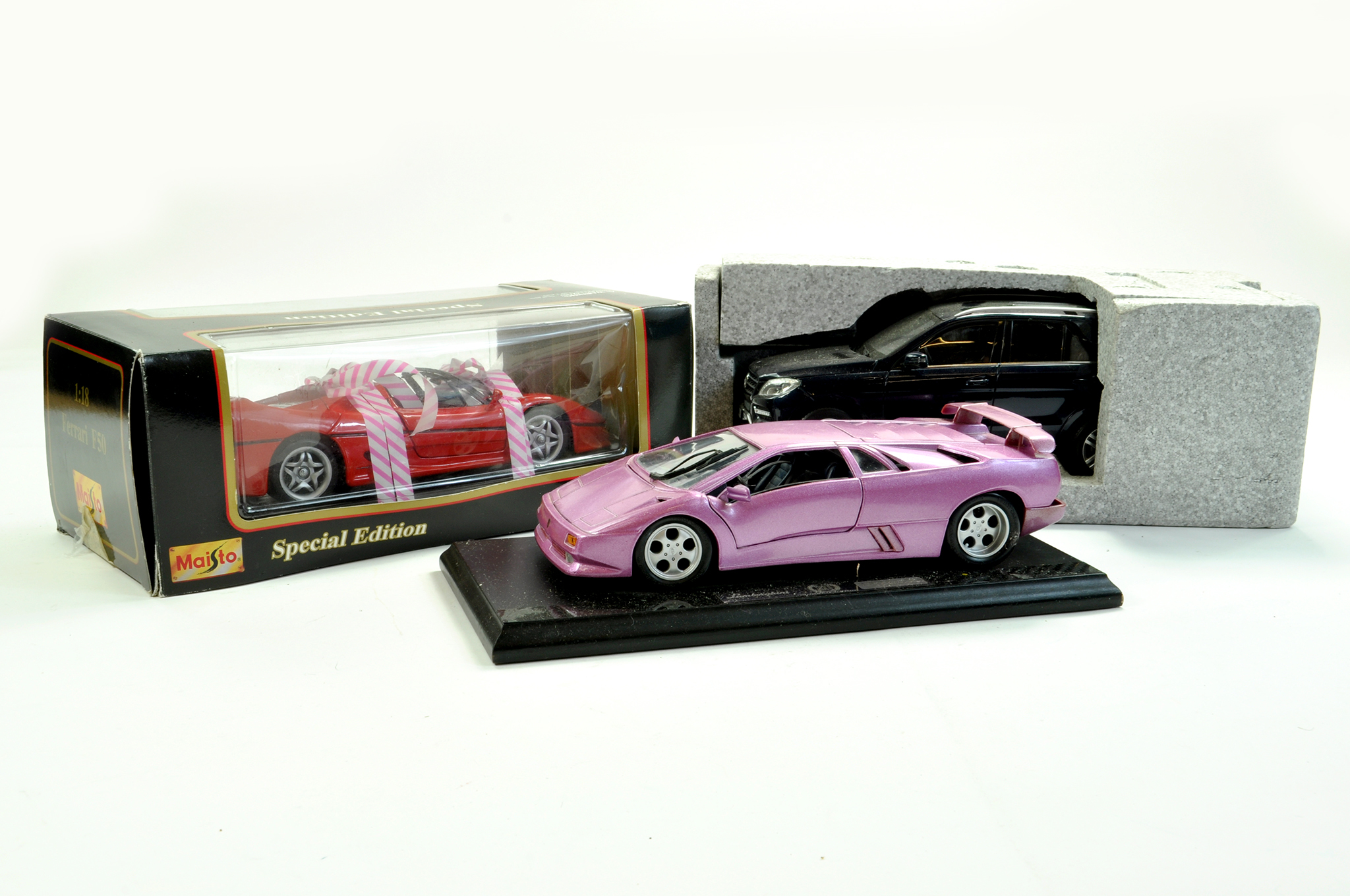 Trio of 1/18 diecast models comprising Lamborghini, Maisto Ferrari F50 and Mercedes 4X4. Generally