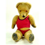 A well-loved vintage bear with vest and pants. He has had a hard life and would benefit from TLC /