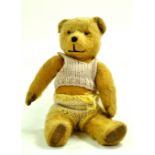 A vintage bear issue. Maintains a good appearance in hand knitted clothes with some expected age