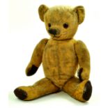 A well loved vintage bear with notable age wear, in need of tlc. Likely British Made. Enhanced