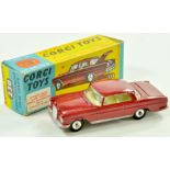 Corgi No. 230 Mercedes 220 SE Coupe with dark red body. Some rubbing and wear, mostly along edges,