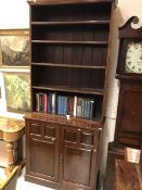 A 19th Century mahogany bookcase cabinet with open adjustable shelving over a pair of fielded