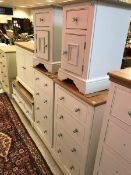 A pair of Painted Furniture Company "Bayview" four drawer chests raised on plinth bases together