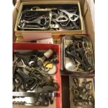 A box containing a collection of various bottle and can openers including "The Bobs" various crown,