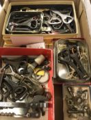 A box containing a collection of various bottle and can openers including "The Bobs" various crown,