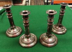 A set of four Georgve III Sheffield plated telescopic candlesticks with beaded decoration by