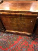 A 19th Century Continental walnut commode of four graduating drawers on bracket feet