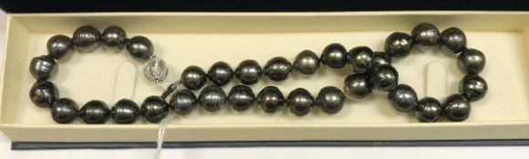 A South Sea (Northern Australian) black pearl necklace with silver clasp,