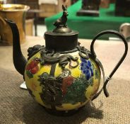 A 19th Century Chinese miniature porcelain teapot with bronze relief embellishments depicting