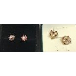A pair of illusion set diamond and ruby ear studs and a pair of seed pearl and ruby ear studs