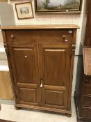 A continental pine cabinet the plain top above single drawer to two cupboard doors raised on turned