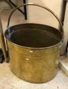 A 20th Century oval brass bucket of oversize proportions