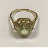A 15 carat gold mounted pale yellow green stone ring (possibly tourmaline), approx 3.