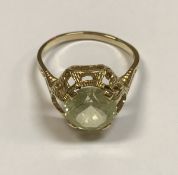 A 15 carat gold mounted pale yellow green stone ring (possibly tourmaline), approx 3.