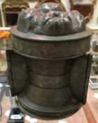 A 19th Century pewter jelly mould with hinged centre section stamped to base "W.