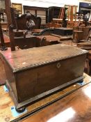 A 19th Century oak lidded box on bun feet