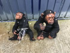 A pair of painted concrete Chimpanzees