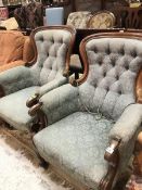 A pair of Victorian spoon-back salon chairs with button backs and upholstered arms raised on ringed