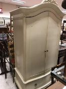 A modern cream painted two door wardrobe in the continental taste